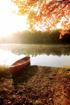 Canoe by lake in autumn